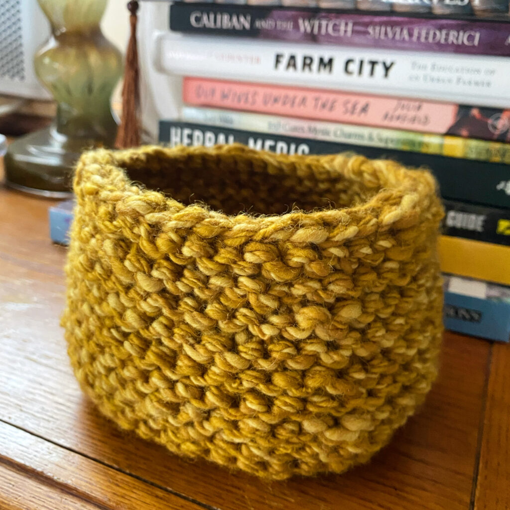 a knitted basket from naturally dyed yarn