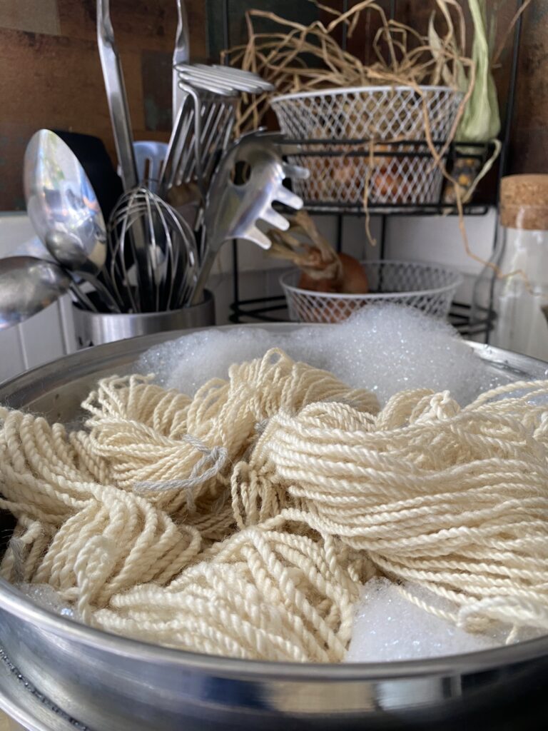 wool yarn being washed to remove any lanolin